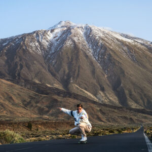 Young Man Longboarding with snowed Teide - Full day Rentals In Tenerife