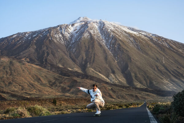 Young Man Longboarding with snowed Teide - Full day Rentals In Tenerife