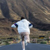 Young Man Longboarding with snowed Teide - Full day Rentals In Tenerife
