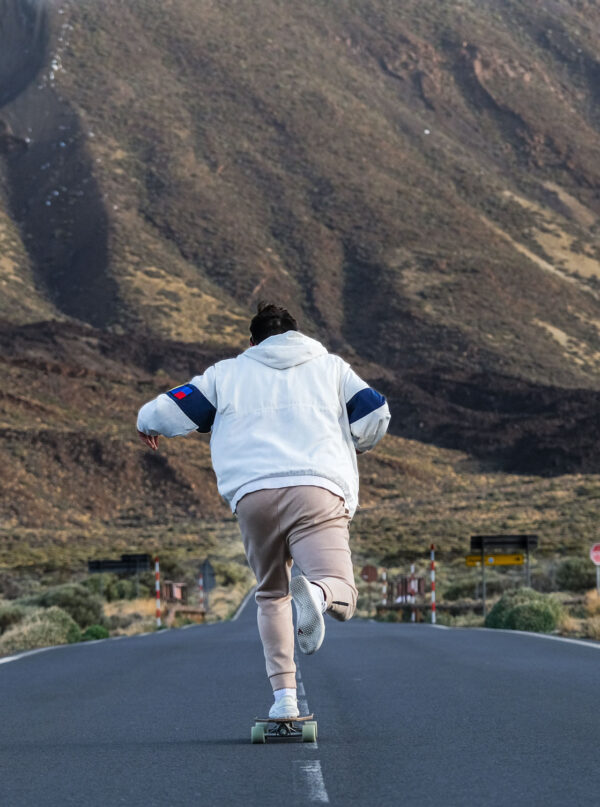 Young Man Longboarding with snowed Teide - Full day Rentals In Tenerife