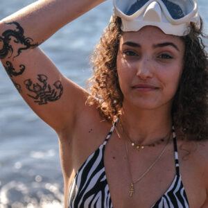 Close-up of woman putting on snorkel mask at Tenerife beach