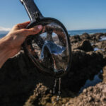 Easybreath mask with water drops and the ocean in the back