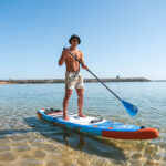 Young Man using paddleboard from tralei rentals in Las teresitas, tenerife