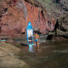 Explorer with stand-up paddleboard in a secluded coastal spot in Tenerife South – full-day SUP rental